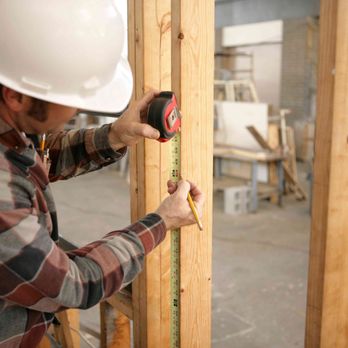 A & D Home Improvements - a construction worker measuring a wall - General Contractors Near Me A & D Home Improvements - a construction worker measuring a wall - General Contractors Near Me