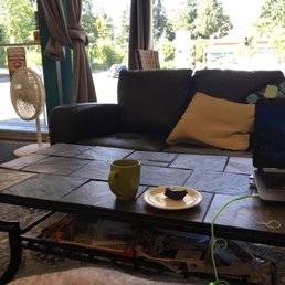 a coffee table with a laptop on it a coffee table with a laptop on it