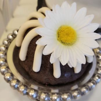Nothing Bundt Cakes - a white flower on top of a bundt cake - Bakeries Near Me - Dallas, Texas Nothing Bundt Cakes - a white flower on top of a bundt cake - Bakeries Near Me - Dallas, Texas