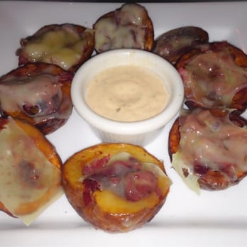 Irish 31 - Potato Pub Skins: Red bliss potatoes stuffed with sauerkraut, corned beef and Swiss Cheese, served with Emerald Isle Dressing - Sports Bars Near Me - Tampa, Florida Irish 31 - Potato Pub Skins: Red bliss potatoes stuffed with sauerkraut, corned beef and Swiss Cheese, served with Emerald Isle Dressing - Sports Bars Near Me - Tampa, Florida