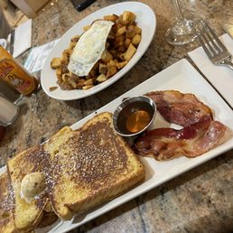 French toast, bacon, homestyle potatoes and an over easy egg. French toast, bacon, homestyle potatoes and an over easy egg.