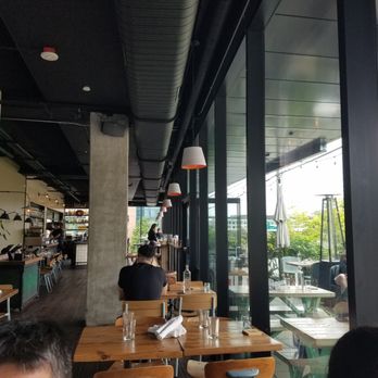 Pablo y Pablo - View of the long and narrow seating area, with covered outdoor seating visible through the windows. - Mexican Near Me - Seattle, Washington