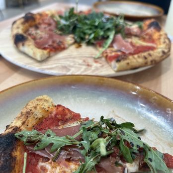 The Outpost - Casa Tra i Rami pizza Artichokes, arugula,prosciutto, mozzarella, basalmic, pine nuts, tomatoes - Pizza Near Me - Riverside, California The Outpost - Casa Tra i Rami pizza Artichokes, arugula,prosciutto, mozzarella, basalmic, pine nuts, tomatoes - Pizza Near Me - Riverside, California