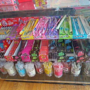Candy 4 Pennies - Novelty side of the store - A glass display case contains assorted candies, including Laffy Taffy, gum, and cotton candy, arranged on shelves. - Candy Stores Near Me - Providence, Rhode Island