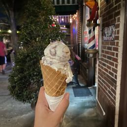 a hand holding an ice cream cone a hand holding an ice cream cone