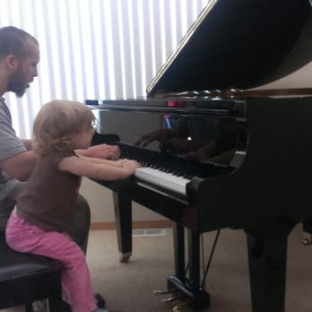 A-1 Pianos - A mover playing with my little girl while the invoice was prepared. He was extremely respectful & she wasn't shy of him at all! - Piano Services Near Me - Bellevue, Washington