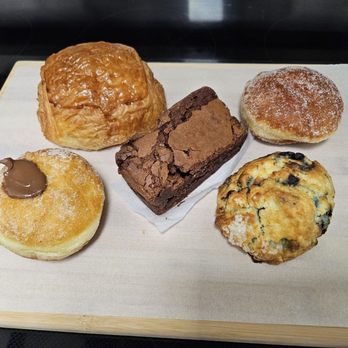 Charmaine Sweets - Clockwise: pain au chocolat, flourless brownie, cinnamon sugar beignet, blueberry scone, Nutella beignet - Bakeries Near Me - Toronto, Ontario Charmaine Sweets - Clockwise: pain au chocolat, flourless brownie, cinnamon sugar beignet, blueberry scone, Nutella beignet - Bakeries Near Me - Toronto, Ontario