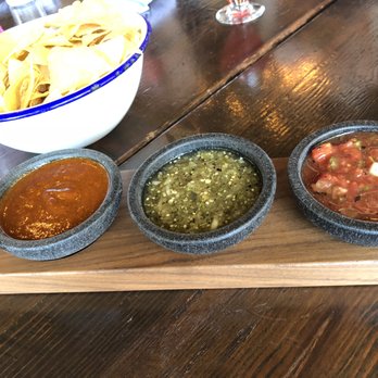 Poquitos - Salsa Trio - Tomato-jalapeño, roasted tomatillo-serrano, and roasted guajillo-tomatillo. Served with chips cooked in rice oil - Mexican Near Me - Seattle, Washington