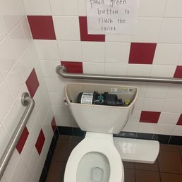Sign asking to flush toilet from the tank