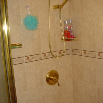Expert Delivery and Assembly - a shower with gold fixtures - General Contractors Near Me - West Babylon, New York Expert Delivery and Assembly - a shower with gold fixtures - General Contractors Near Me - West Babylon, New York