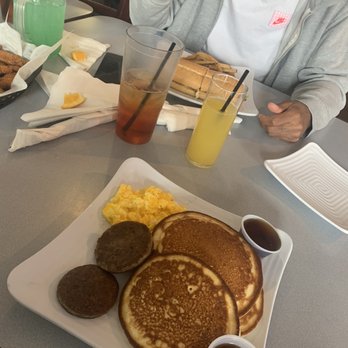 The Comfy Belly - a woman sitting at a table with a plate of pancakes and eggs - Bars Near Me - Virginia Beach, Virginia The Comfy Belly - a woman sitting at a table with a plate of pancakes and eggs - Bars Near Me - Virginia Beach, Virginia