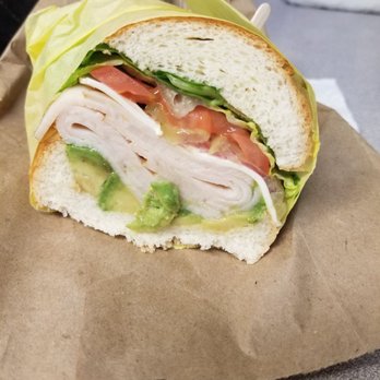 Delroy's Deli & Catering - Half of my Turkey, Swiss & avacado sandwich (w/ lettuce, pickles, tomatoes & red onion) on white Geneva roll. Yum! Always fresh. - Soul Food Near Me - Stockton, California