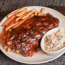 The Perk - Babyback Ribs: slow roasted until they fall off the bone, brushed with BBQ sauce, served with fries and slaw. Half Rack 16.99