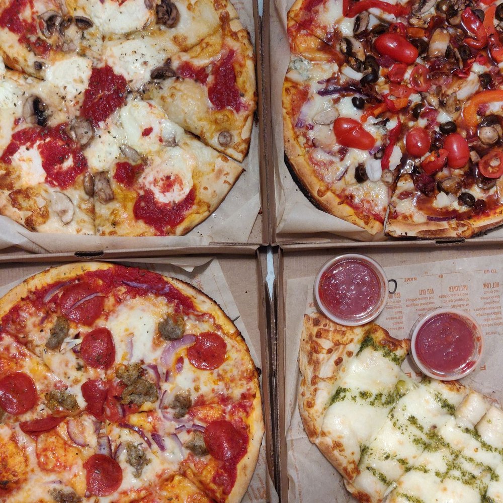 Clockwise   art lover + mushroom, bbq chicken, meat lovers , pesto cheese bread. It was aight
