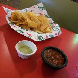 Chips, warm salsa, and delicious green sauce