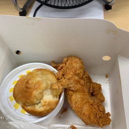 Chicken tenders with biscuit and side.