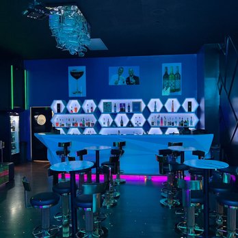 Melange - a bar with stools and neon lights - New American Near Me - Canton, Ohio