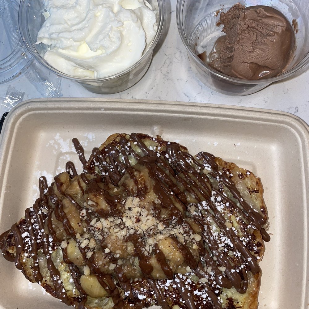 Nutella Cafe - Croissant french toast with banana foster, hazelnuts, side of nutella gelato and whipped cream - Desserts Near Me - Chicago, Illinois Nutella Cafe - Croissant french toast with banana foster, hazelnuts, side of nutella gelato and whipped cream - Desserts Near Me - Chicago, Illinois