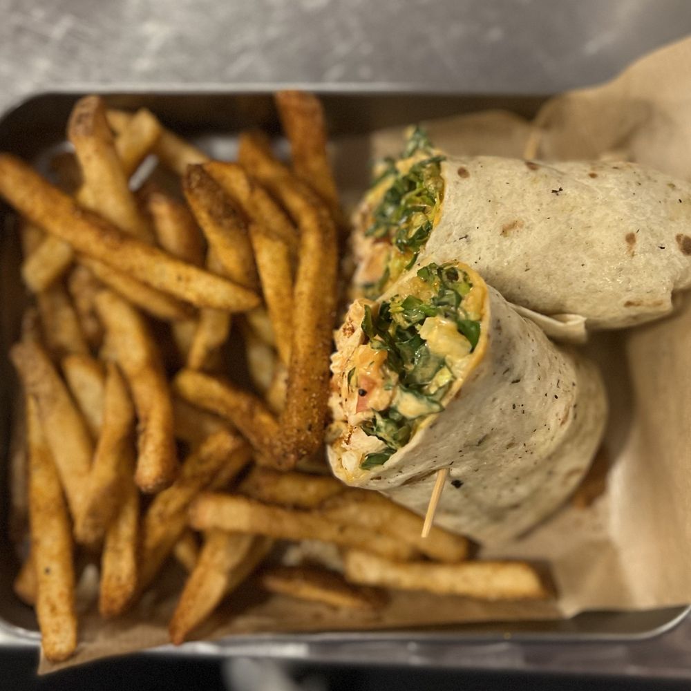 The District Pub & Grill - Buffalo Chicken Wrap with Cajun Fries - New American Near Me - Eau Claire, Wisconsin The District Pub & Grill - Buffalo Chicken Wrap with Cajun Fries - New American Near Me - Eau Claire, Wisconsin