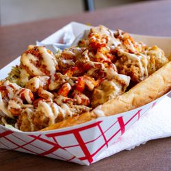 Soul Ona Roll Sac - Bayou Classic (grilled shrimp, crawfish, and crispy gator on a french roll with housemade remoulade and pickled slaw) - $20