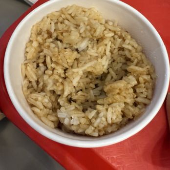 Jollibee - Adobo Rice - A bowl of adobo rice, a Filipino-inspired dish, is placed on a red tray at Jollibee in Chicago, IL. - Fast Food Near Me - Chicago, Illinois