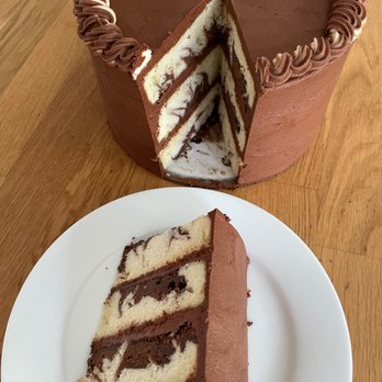 Betts Bakes - 3 layers of marble cake covered in chocolate buttercream frosting. - Cupcakes Near Me
