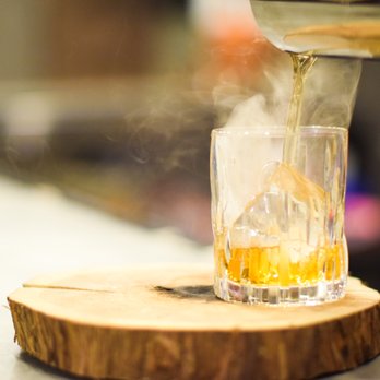 LARS Bar & Restaurant - a person pouring a drink into a glass - New American Near Me - Bloomington, Minnesota