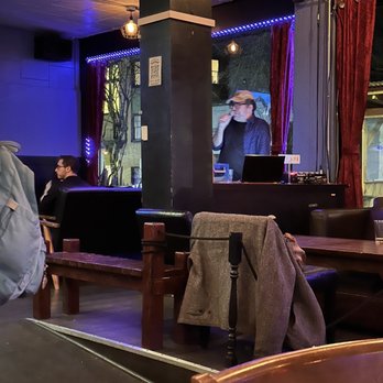 The Pharmacy - a man sitting at a table with a laptop - Cocktail Bars Near Me - Portland, Oregon The Pharmacy - a man sitting at a table with a laptop - Cocktail Bars Near Me - Portland, Oregon