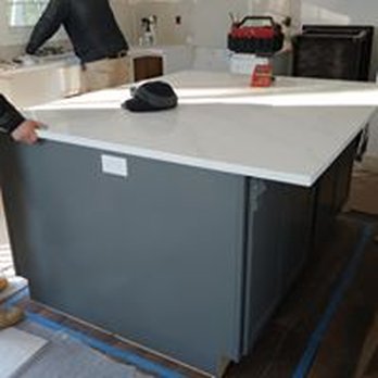 Downs Building Construction - two men working on a kitchen island - General Contractors Near Me Downs Building Construction - two men working on a kitchen island - General Contractors Near Me