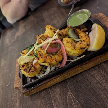 Mantra by Host - a plate of food on a wooden table - Indian Near Me - Toronto, Ontario