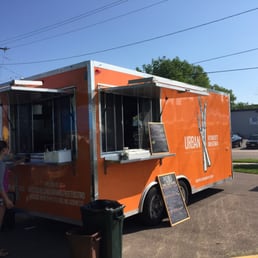 a food truck parked in a parking lot a food truck parked in a parking lot