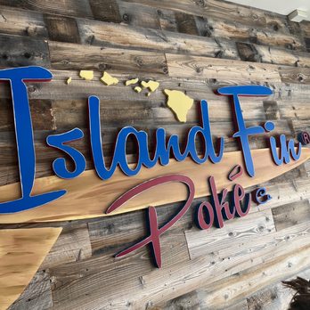 Island Fin Poke - a woman standing in front of a sign - Poke Near Me - Cos Cob, Connecticut Island Fin Poke - a woman standing in front of a sign - Poke Near Me - Cos Cob, Connecticut
