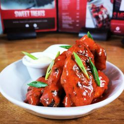 The Grill Eastham - BUFFALO WINGS - Chargrilled buffalo wings complimented with our rich spicy tangy sauce served with our citrus dip