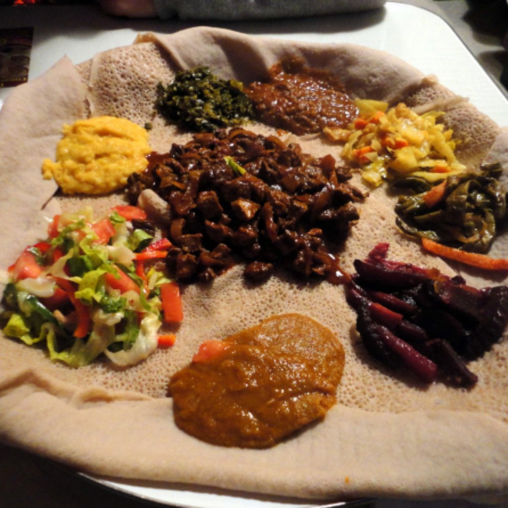 Dilla's - Yebeg Tibs (Lamb) which was plated in the middle, surrounded by our other dish, the #39 Veggie Combo - Ethiopian Near Me - Minneapolis, Minnesota Dilla's - Yebeg Tibs (Lamb) which was plated in the middle, surrounded by our other dish, the #39 Veggie Combo - Ethiopian Near Me - Minneapolis, Minnesota