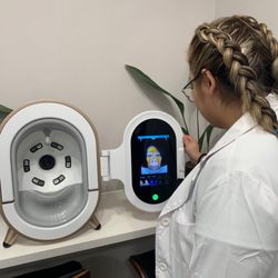 La Riviere Beauty Boutique - My amazing esthetician doing my skin analysis before my skin tightening radio frequency facial treatment
