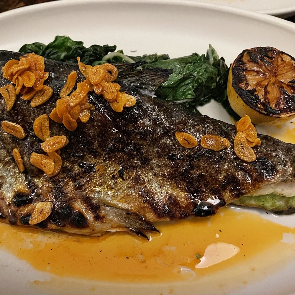 Tito & Pep - Grilled trout with crispy garlic and greens. - New American Near Me - Tucson, Arizona Tito & Pep - Grilled trout with crispy garlic and greens. - New American Near Me - Tucson, Arizona