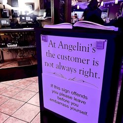 Angelini's Ristorante - Host desk. "At Angelina's the customer is not always right." "if this sign offends you please leave before you embarrass yourself."