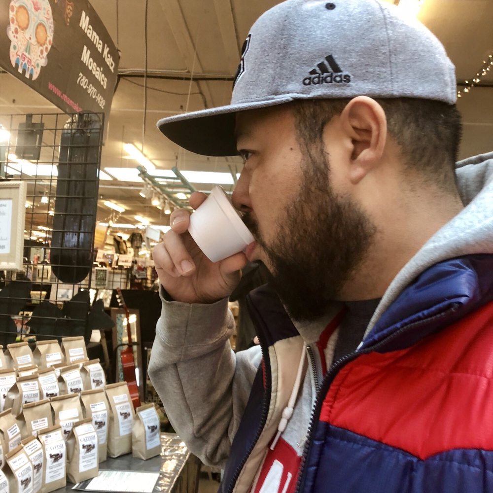 Old Strathcona Farmer's Market - My boyfriend George, trying out some sample coffee at Catfish Coffee Roasters. - Fruits & Veggies Near Me - Edmonton, Alberta Old Strathcona Farmer's Market - My boyfriend George, trying out some sample coffee at Catfish Coffee Roasters. - Fruits & Veggies Near Me - Edmonton, Alberta