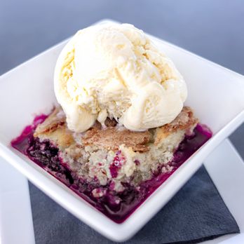 5 Under Golf Center - blackberry & peach cobbler with sweet, cake-like crust and topped with vanilla ice cream - Golf Equipment Near Me - Beaumont, Texas