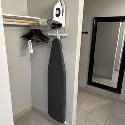 A place to hang your clothes, including iron and ironing board. A place to hang your clothes, including iron and ironing board.