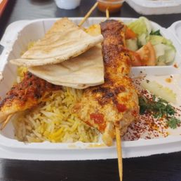 Chicken Kabob with rice, salad and that sauce. Chicken Kabob with rice, salad and that sauce.