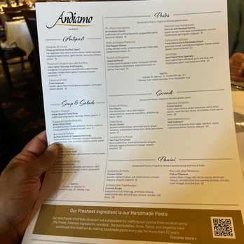 Andiamo - a person holding a menu at a restaurant - Italian Near Me - Warren, Michigan Andiamo - a person holding a menu at a restaurant - Italian Near Me - Warren, Michigan