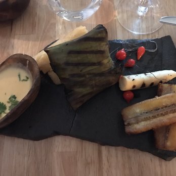 Llama Restaurant - Arapaima wrapped in banana leaf & grilled.  Served passion fruit sauce, grilled heart of palm & fried yucca.  Yum! - Peruvian Near Me - Saint Augustine, Florida