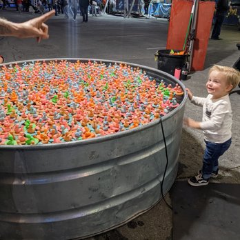 Winter Fest OC - All duckies = a prize. This little guy couldn't choose! Look at that joy! - Festivals Near Me - Costa Mesa, California