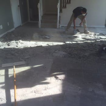 Quality Flooring - Before picture of Koko's workers removing some hard stone in our family room. - Flooring Near Me - Rancho Cucamonga, California