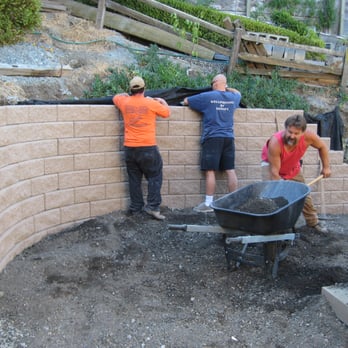 Corey & Sons Construction - some of the crew at work on a block retaining wall - General Contractors Near Me - Los Gatos, California