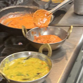 Mother India Restaurant - F10. Butter Chicken Masala and G1. Dal being spooned into serving dishes - Indian Near Me - Chatsworth, California Mother India Restaurant - F10. Butter Chicken Masala and G1. Dal being spooned into serving dishes - Indian Near Me - Chatsworth, California