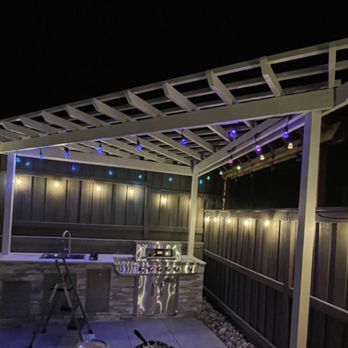 ST Landscape Management - a pergolated patio at night - Landscaping Near Me ST Landscape Management - a pergolated patio at night - Landscaping Near Me