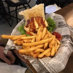The Hound Pub & Dining - One of the burgers offered with hand made beef patty, fresh vegetables and cheese, bacon, caramelized onion on a freshly baked bun