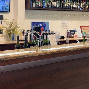 Post Winery - a bar with bottles of wine on the counter - Wine Tours Near Me - Altus, Arkansas